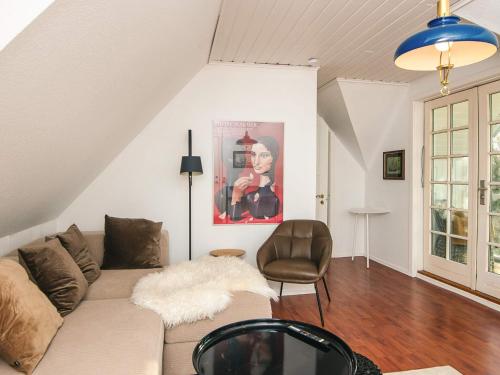 a living room with a couch and a chair at Hotel Strandvejen near beach in Fanø