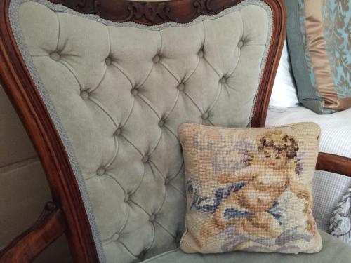 a pillow with a picture of a baby on a chair at Kurrara Historic Guest House in Katoomba