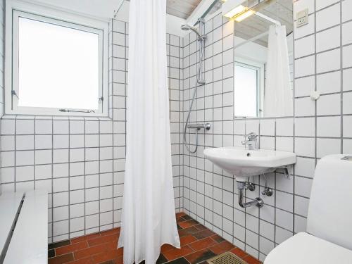 a white bathroom with a sink and a window at Type2 holiday home in Hanstholm in Hanstholm