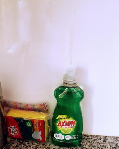 a green bottle of ketchup sitting next to some food at la fenice un apartamento de ensueño en Las Terrenas playa Punta Popy in Las Terrenas