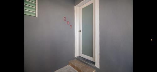 a mirror on a wall next to a stair case at Playa Isla Verde - Beautiful 2 bed - 2 bath! in San Juan