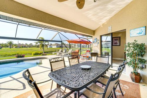 a patio with a table and chairs next to a pool at Near Golf and Beaches Luxe Home in Rotonda West! in Rotonda West