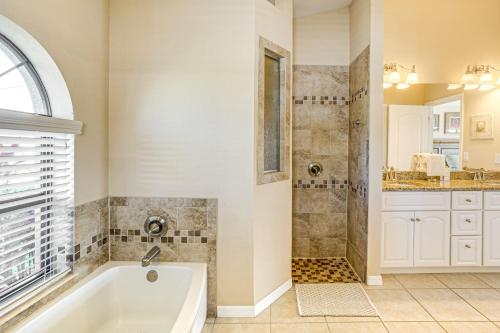 a bathroom with a tub and a shower and a sink at Near Golf and Beaches Luxe Home in Rotonda West! in Rotonda West
