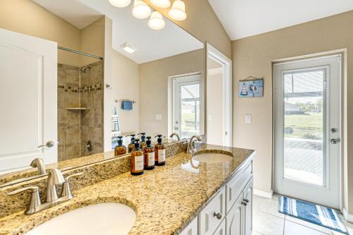 a bathroom with two sinks and a large mirror at Near Golf and Beaches Luxe Home in Rotonda West! in Rotonda West