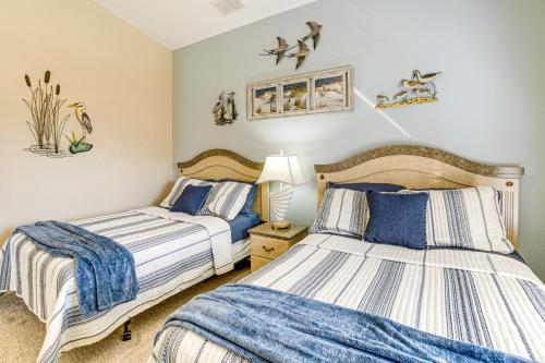 two beds in a bedroom with blue and white sheets at Near Golf and Beaches Luxe Home in Rotonda West! in Rotonda West