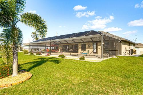 a house with a palm tree in front of it at Near Golf and Beaches Luxe Home in Rotonda West! in Rotonda West