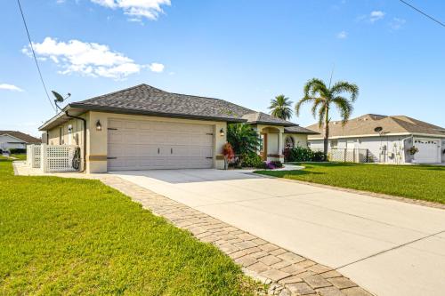a house with a garage and a driveway at Near Golf and Beaches Luxe Home in Rotonda West! in Rotonda West