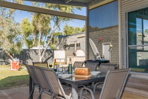 a dining table and chairs on a patio at Break-A-Way - Coastal comfort in lancelin in Lancelin