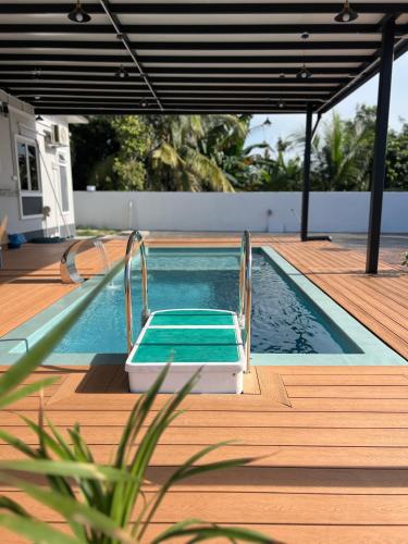a swimming pool on a wooden deck next to a house at KLIA HBO Villa Homestay in Nilai