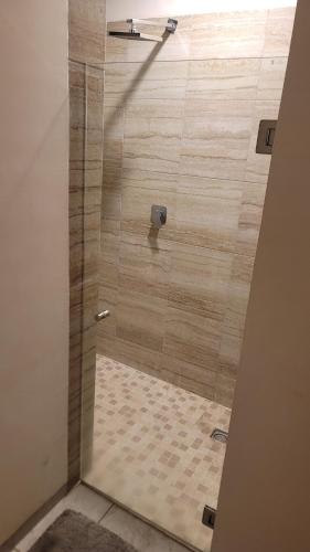 a shower with a glass door in a bathroom at Casa Moderna en privada in La Laborcita