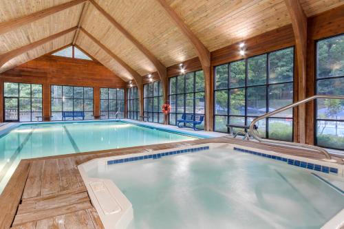 an indoor pool in a house with windows at Fairway Forest in Sapphire