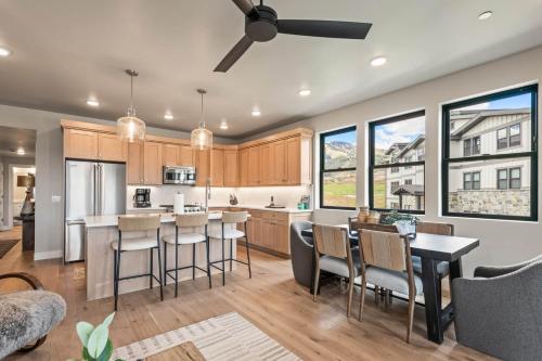 una cocina con armarios de madera y una isla de cocina con taburetes en Mayflower Lakeside 1169-201, en Heber City