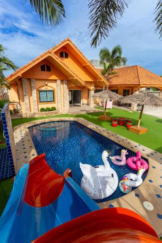 a house with a swimming pool with a water slide at The Orange House Pool Villa Pattaya in Jomtien Beach