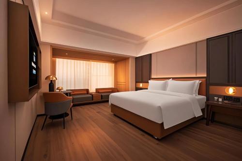 Postel nebo postele na pokoji v ubytování Mehood Lestie Hotel Dongguan Chang'an