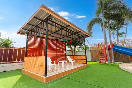 a play structure with two chairs and a slide at The Orange House Pool Villa Pattaya in Jomtien Beach