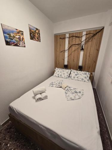 a bedroom with a bed with white sheets and pillows at Luxury Angel Apartments 3 in Paralia Katerinis