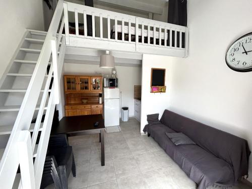 - un salon avec un canapé et un réveil dans l'établissement Maison proche plage avec terrasse et parking - FR-1-837-8, à Argelès-sur-Mer