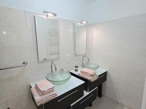 a bathroom with two sinks and a mirror at Charmante maison près de Bergerac avec jardin privatif - FR-1-616-482 in Ginestet
