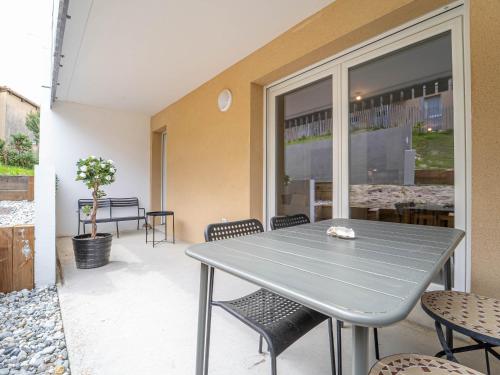 une table et des chaises gris sur une terrasse dans l'établissement Mimizan Plage - T2 cosy, 4 pers, 400m océan - FR-1-50-180, à Mimizan