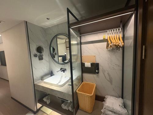 a bathroom with a sink and a mirror at Atour X Hotel West Nanjing Road in Shanghai