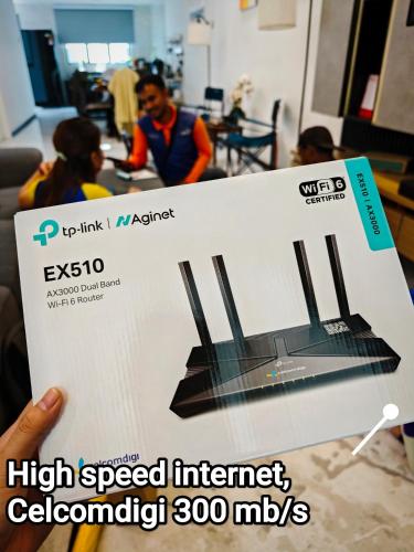 a person holding up a sign that says high speed internet mips at D Banyan Homestay, Bukit Banyan in Sungai Petani