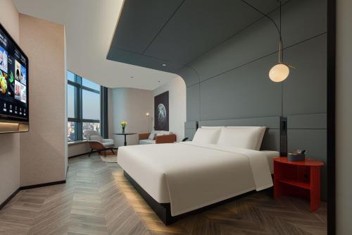 Postel nebo postele na pokoji v ubytování Atour S Hotel Hangzhou Binjiang Changhe Jiangnan Avenue
