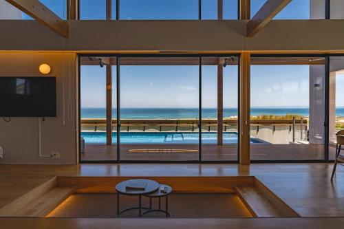 a living room with a view of the ocean at SETO CLAS TSUDA THE BEACH RESORT A in Yoshimi