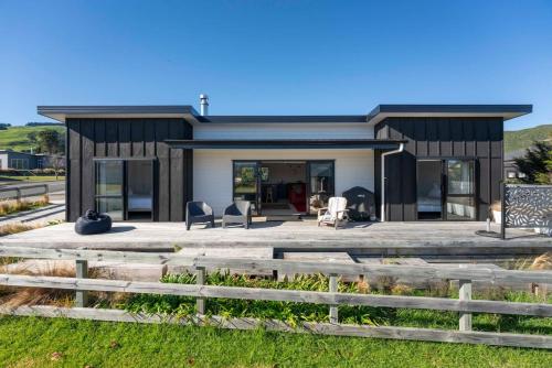a house on the beach with a deck at Dragonflys Rest in Kinloch