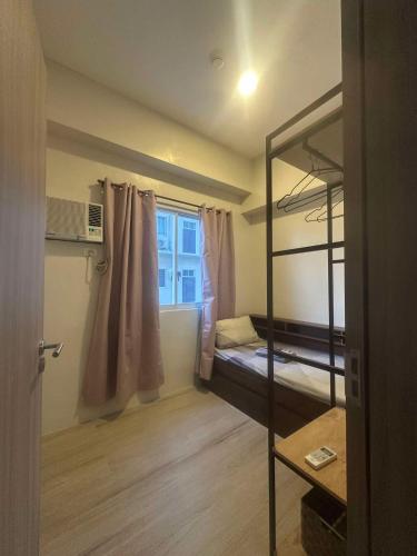 a room with two bunk beds and a window at Condo - 2 Bedrooms Family with Balcony in Basak