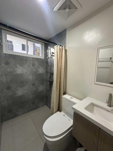 a bathroom with a toilet and a shower and a sink at Condo - 2 Bedrooms Family with Balcony in Basak