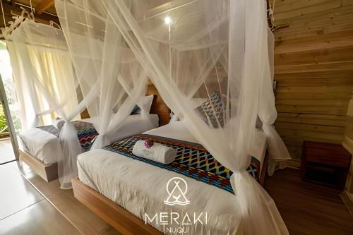 Hotel Meraki Nuquiにあるベッド