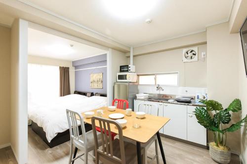a kitchen and dining room with a table and chairs at VIVA Apartment Yabacho in Nagoya