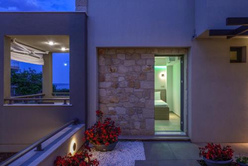 a house with a window and flowers on the porch at Marthina Luxury Living in Nea Potidaea