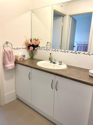 a bathroom with a sink and a mirror at Owl House on the Corner in Kingscote