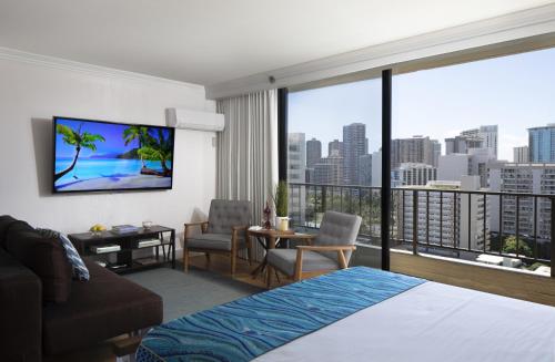 a hotel room with a bed and a large window at Refreshing Royal Garden Studio condo in Honolulu