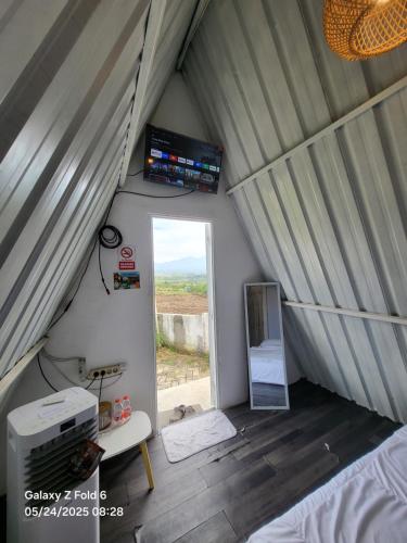 a room with a bed and a window in a tent at Crazy Steak Resort Glamping Villa Resto 24h in Batu