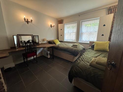a bedroom with a desk and a bed and a desk with a mirror at Seven Sisters, Glastonbury in Glastonbury