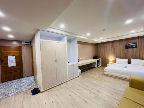 a hotel room with a bed and a closet at USABAI Riverside Boutique Hotel in Chanthaburi