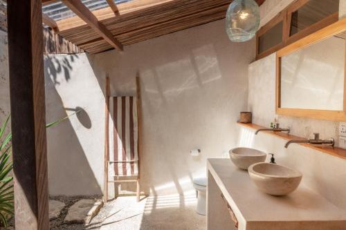 a bathroom with two sinks on a counter at Rote Beach House in Nembrala