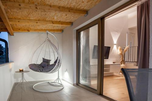 a room with a hammock hanging from the ceiling at Grgurić Apartments in Rab