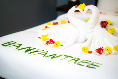 a birthday cake with swans and the words happy anniversary at River Nest Hostel in Kampot