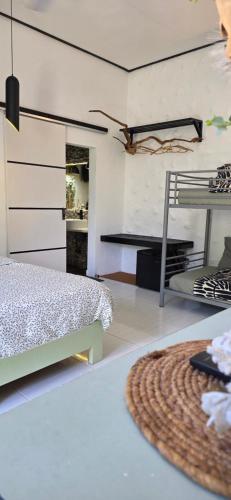 a living room with a bed and a rug at Chambao Maldives in Guraidhoo