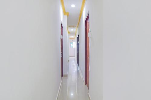 an empty corridor in a hospital building with a hallway at SPOT ON Nirvaan Guest House in Kāhārpāra