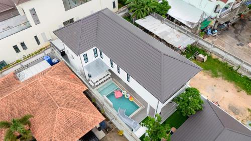 an overhead view of a house with a swimming pool at The White House Pool Villa Pattaya in Jomtien Beach