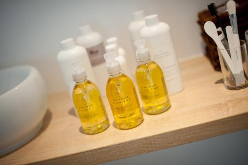 three bottles of oil sitting on a wooden shelf at La Ferme du Cayla in Linac