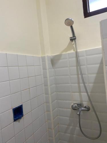 a shower with a shower head in a bathroom at SH Hotel - 20 Second to the Bach by Micky Studio R in Legian