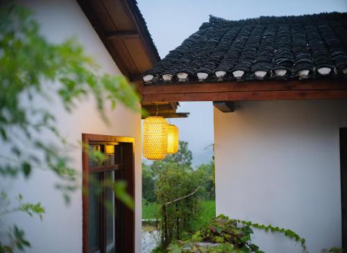 a building with a chandelier hanging from a roof at Zhangjiajie Ldyllic Pondside Timber Lodge in Zhangjiajie