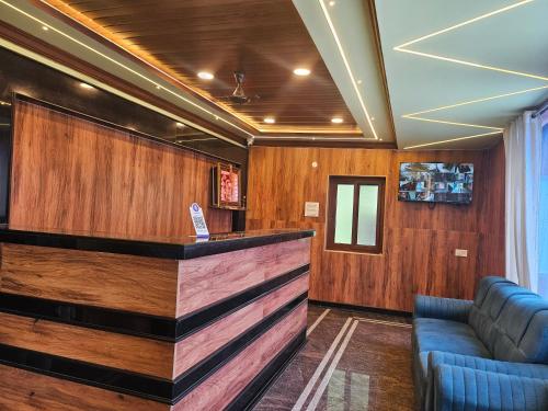 a bar in a room with wooden walls at SR Hotel in Renigunta