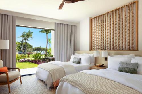 a hotel room with two beds and a window at Mauna Lani, Auberge Collection in Puako
