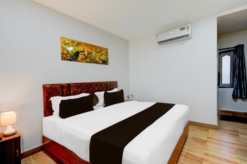 a bedroom with a large white bed in a room at Super Townhouse Vanasthalipuram Near Deer National Park in Hyderabad